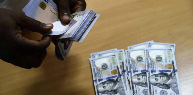 Hands counting US hundred-dollar banknotes on table