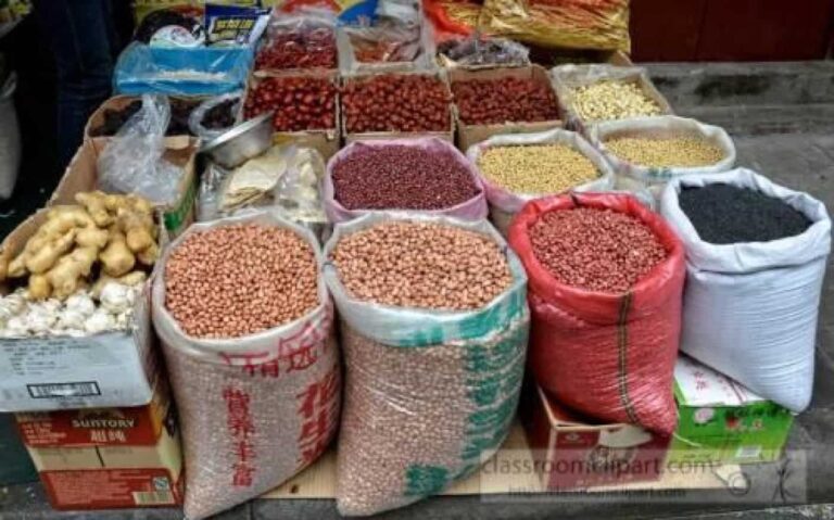 Market stall displaying sacks of beans and grains