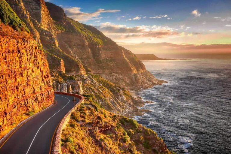 Winding coastal road along cliffs at sunset