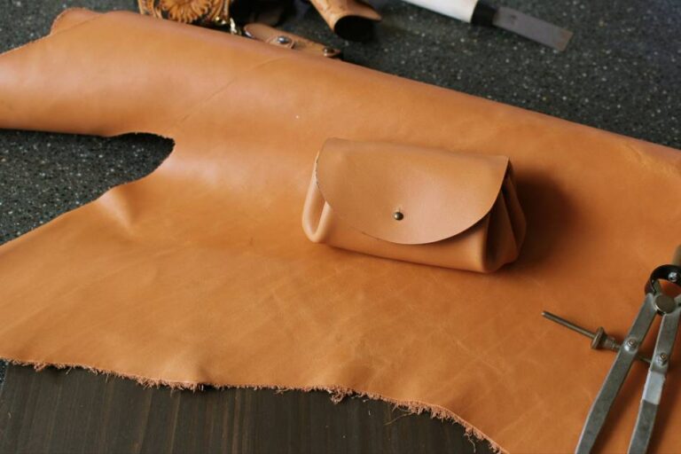 Handmade leather pouch on tan leather sheet