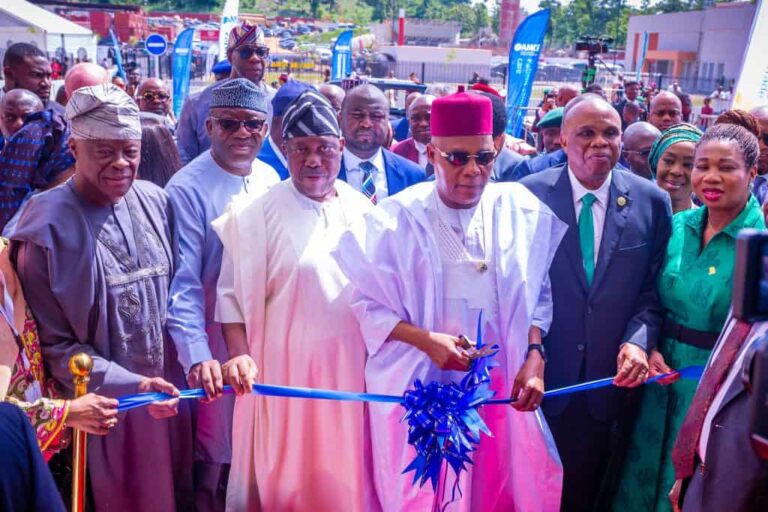 Officials cutting blue ribbon at opening ceremony