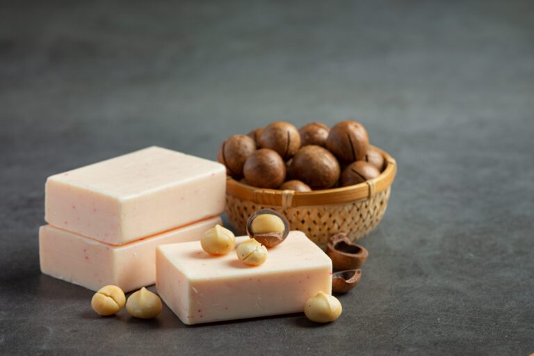 Macadamia nuts and handmade soap bars on table