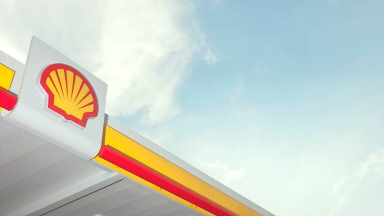 Shell petrol station sign against blue sky