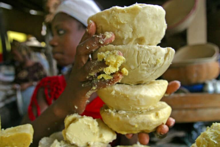 Person holding stacked rounds of fresh butter