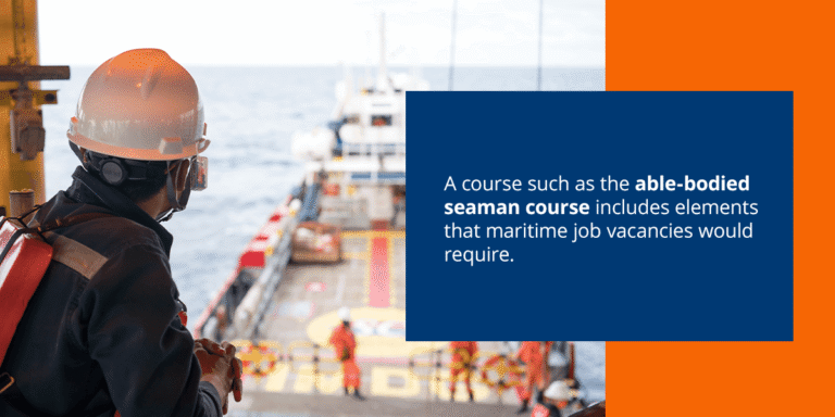 Seafarer in hard hat on ship deck at sea